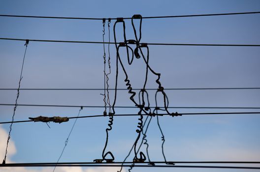 The beam catenary wires against the blue sky