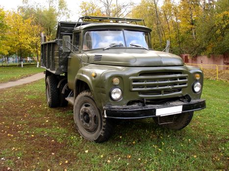 Old Russian tipper lorry ZIL on grass, autumn shot