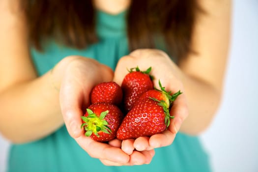 beautiful strawberries in models hands