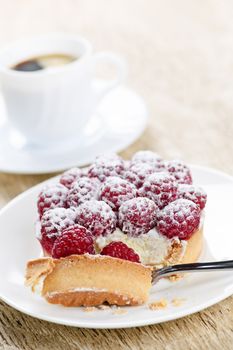 Fresh raspberry tart served with coffee for dessert