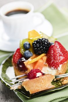 Fresh mixed berry tart served with coffee for dessert