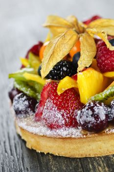 Fresh dessert fruit tart covered in assorted tropical fruits