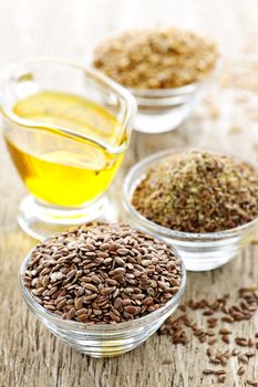 Bowls of whole and ground flax seed with linseed oil