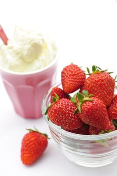 Bowl of fresh organic red strawberries with whipped cream