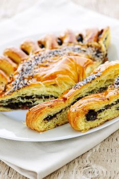 Closeup of poppy seed strudel dessert pastry with slices