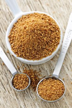 Organic coconut palm sugar in measuring spoons