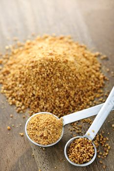 Organic coconut palm sugar in measuring spoons