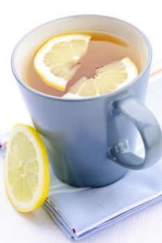 Cup of fresh hot tea with lemon slices