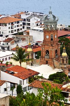 Cityscape view from above with church and Pacific ocean in Puerto Vallarta, Mexico