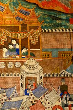 Ancient Buddhist temple mural depicting a Thai daily life scene at Wat Phumin, a famous temple in Nan province, Thailand. The temple is open to the public and has beautiful murals on the walls.