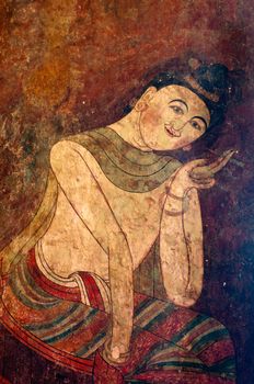 Ancient Buddhist temple mural depicting a Thai daily life scene at Wat Phumin, a famous temple in Nan province, Thailand. The temple is open to the public and has beautiful murals on the walls.