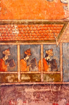 Ancient Buddhist temple mural depicting a Thai daily life scene at Wat Phumin, a famous temple in Nan province, Thailand. The temple is open to the public and has beautiful murals on the walls.