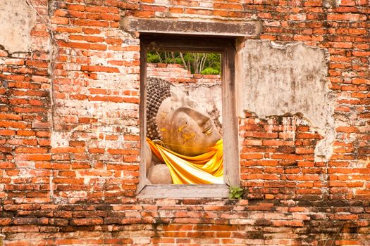 Sleeping Buddha Statue in Window at Wat Putthaisawan Temple Ayutthaya , Thailand.