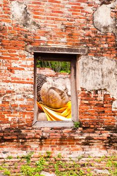 Sleeping Buddha Statue in Window at Wat Putthaisawan Temple Ayutthaya , Thailand.