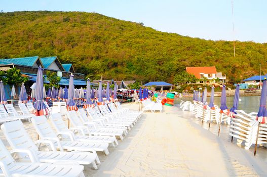 Beach chair and colorful umbrella on the beach