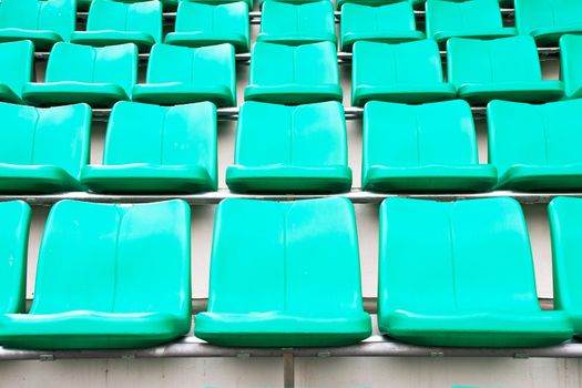 plastic green chairs in stadium