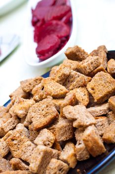 Closee up of croutons with beet in the backgroung
