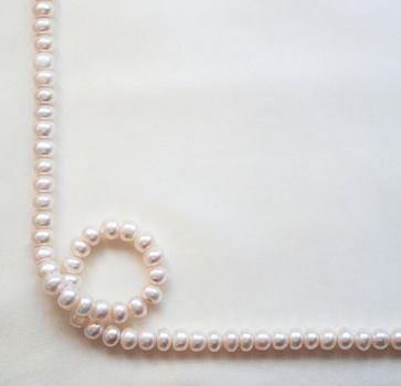 Smooth elegant white silk with pearls can use as wedding background 