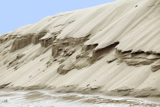 Dry sand escarp on a river, view from below