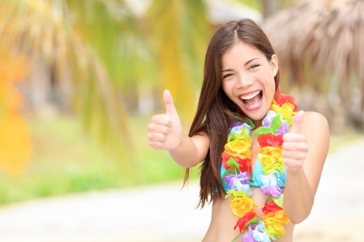 Vacation summer fun woman showing thumbs up smiling happy in joyful bliss. Pretty mixed race Asian / Caucasian female bikini model cheerful on beach.