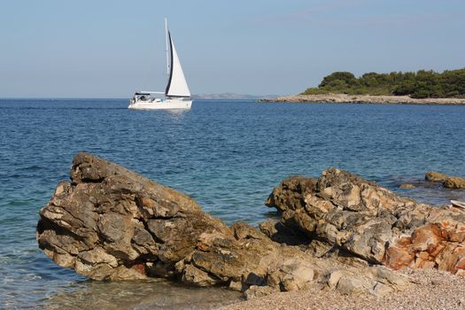 Dalmatian seascape with a yacht sailing
