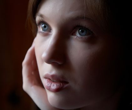 Portrait of the girl in a dark tonality on a dark background