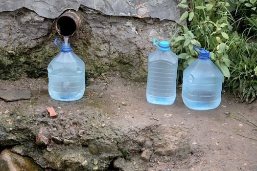 Bottles with water from a spring in the summer