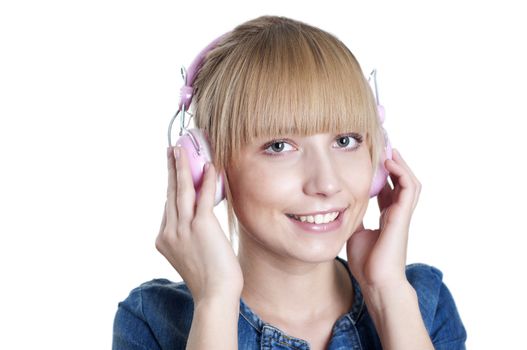 Young attractive woman listing to music with headphones against white background