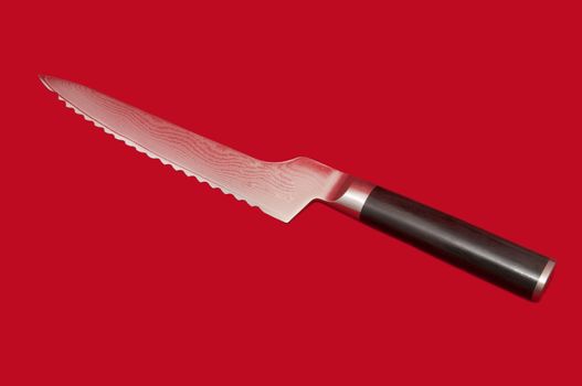 kitchen knife for bread on a red background