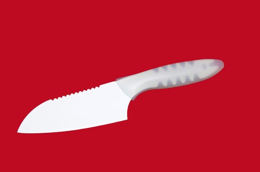 kitchen knife with a ceramic coating on a red background