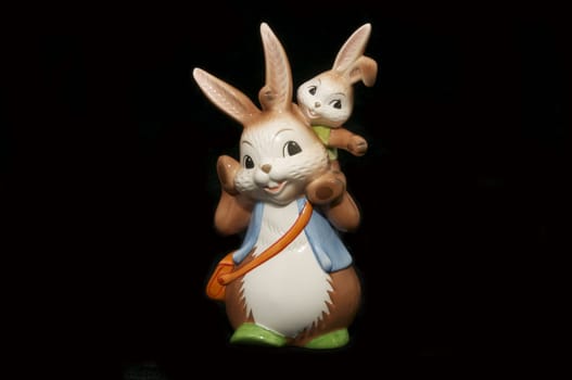 two ceramic Easter bunny  on a black background