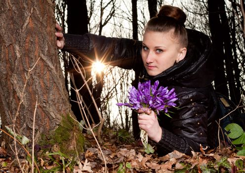 beautiful girl with snowdrops in a forest