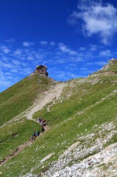 summer landscpe of Italian Dolomites with a group of  hikers in action
