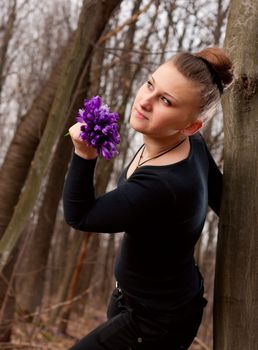 beautiful girl with snowdrops in a forest