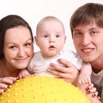 Portrait of a young family on a white background. The father, mum and the kid
