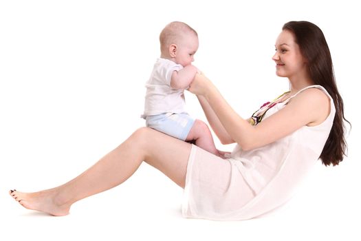 Young mum plays with the small son. A portrait on a white background. The child sits in a lap at mum, mum looks at the son. A horizontal.