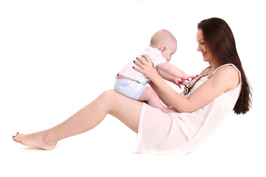 Young mum plays with the small son. A portrait on a white background. The child sits in a lap at mum, they look against each other. A horizontal.