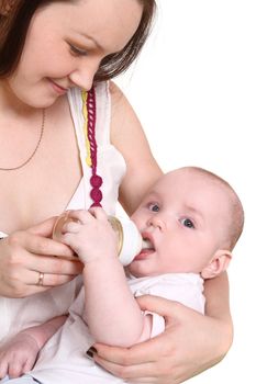 Young mum feeds from a small bottle of the small son