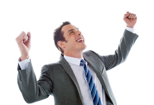 Businessman celebrating success with arms up isolated over a white background