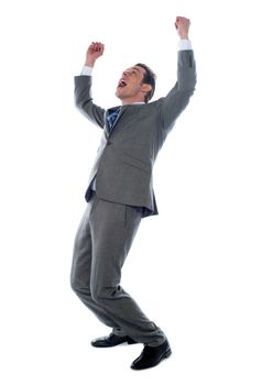 Successful businessman celebrating with arms up isolated over a white background