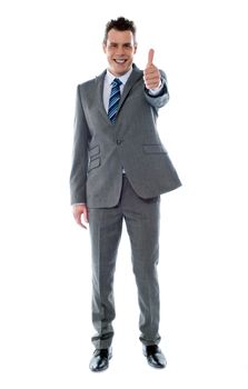 Confident businessman gesturing thumbs up isolated over white