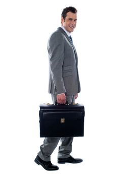 Going business man holding briefcase over white