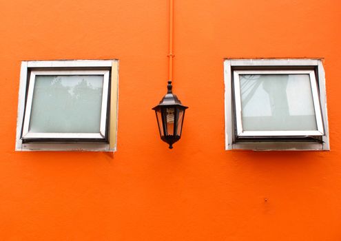 old lamp with windows on orange wall