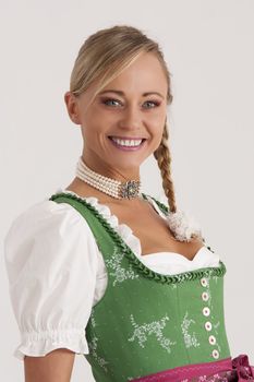 Portrait of a girl in the green Bavarian dirndl