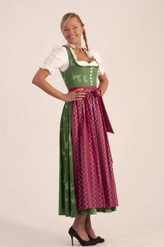 Portrait of a girl in the green Bavarian dirndl