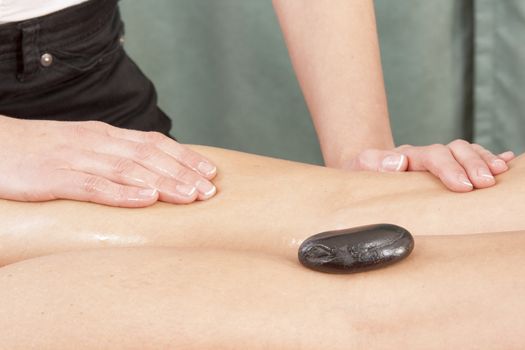 Leg massage with hot stones and oil