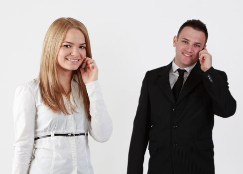 Young couple using mobile phones.Selective focus on the blonde woman.