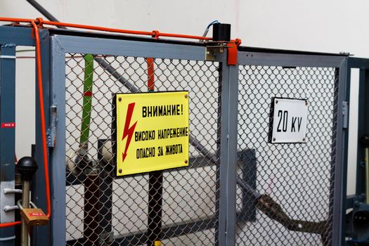 High voltage warning signs on a fence before the equipement