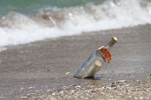 Message in a bottle with a wave coming