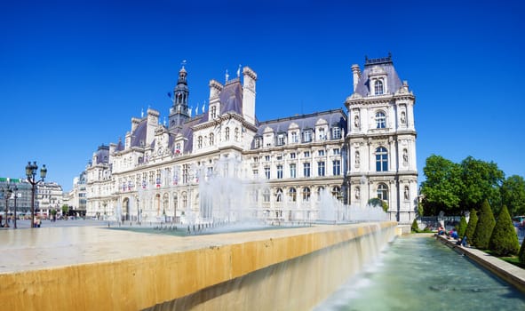 Panoramic photo of Paris City Hall (Hotel de ville) with fountains and blue sky